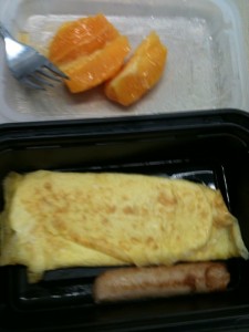 Eggs + some type of sausage + 3 pieces orange